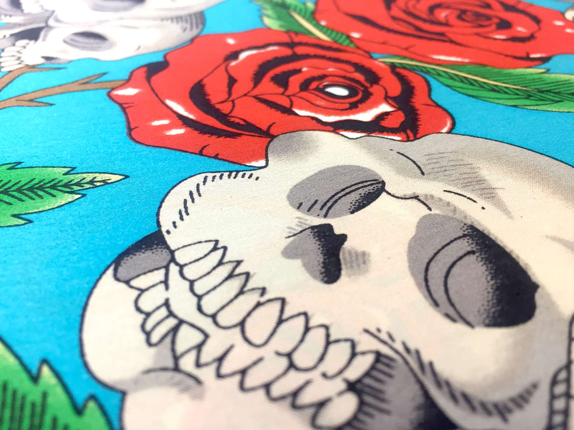 Printed Silk Charmeuse with Skulls and Roses in Blue Background