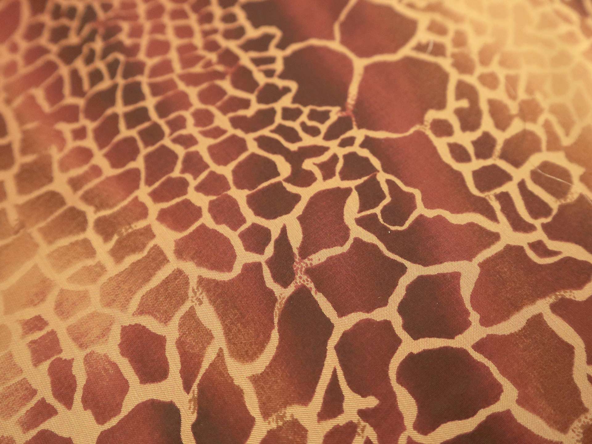 Printed Silk Chiffon with Animal Print On Orange-Red Background