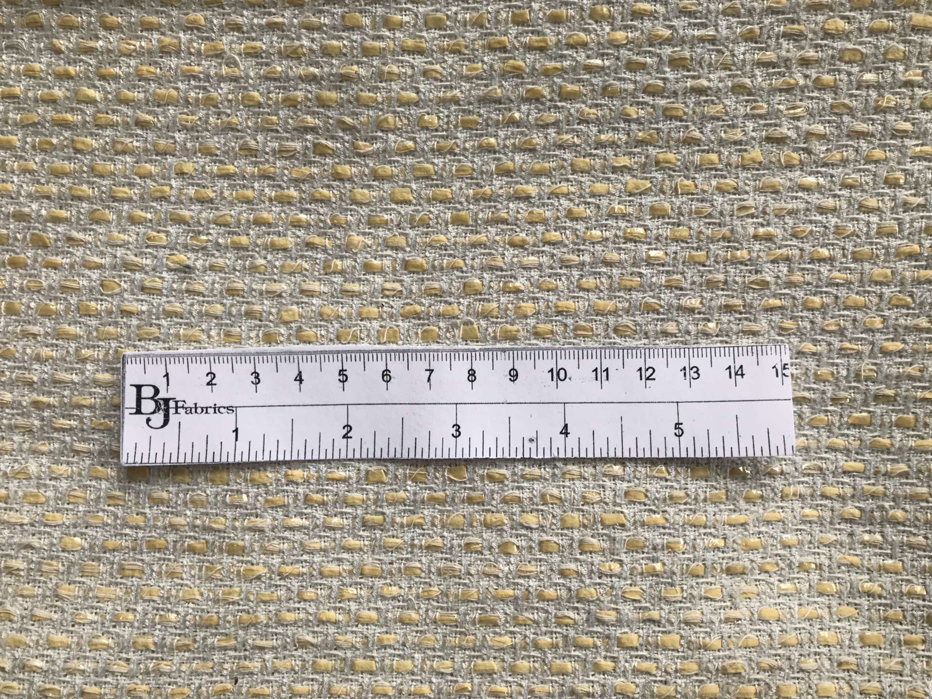 ruler lays on top of tweed to show scale of weave