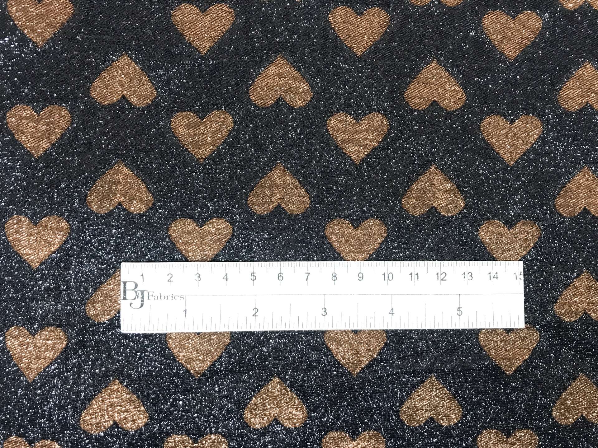 black metallic chiffon with brown hearts with ruler to show scale
