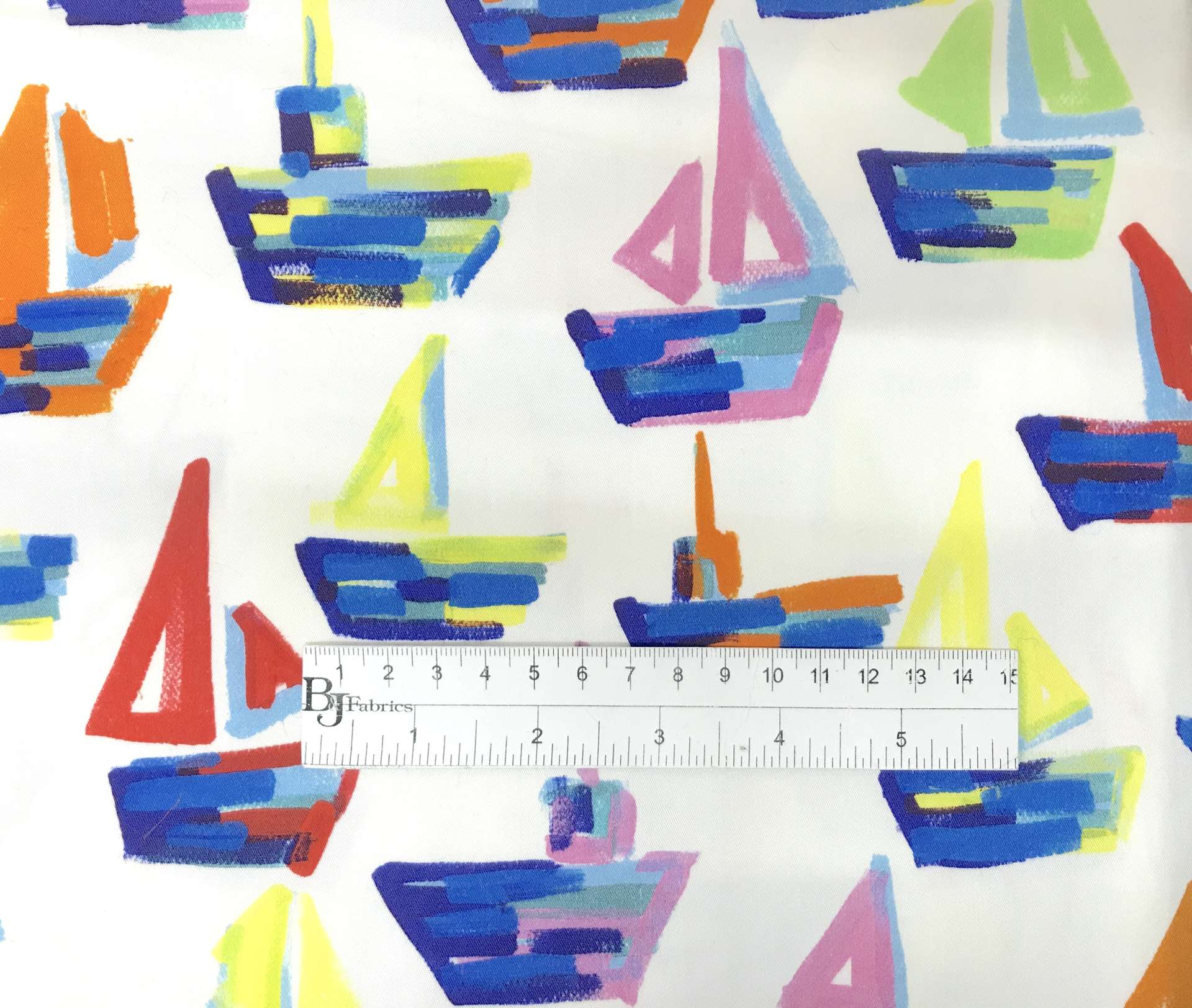 printed white cotton and lycra with colorful painted sailboats with ruler for scale