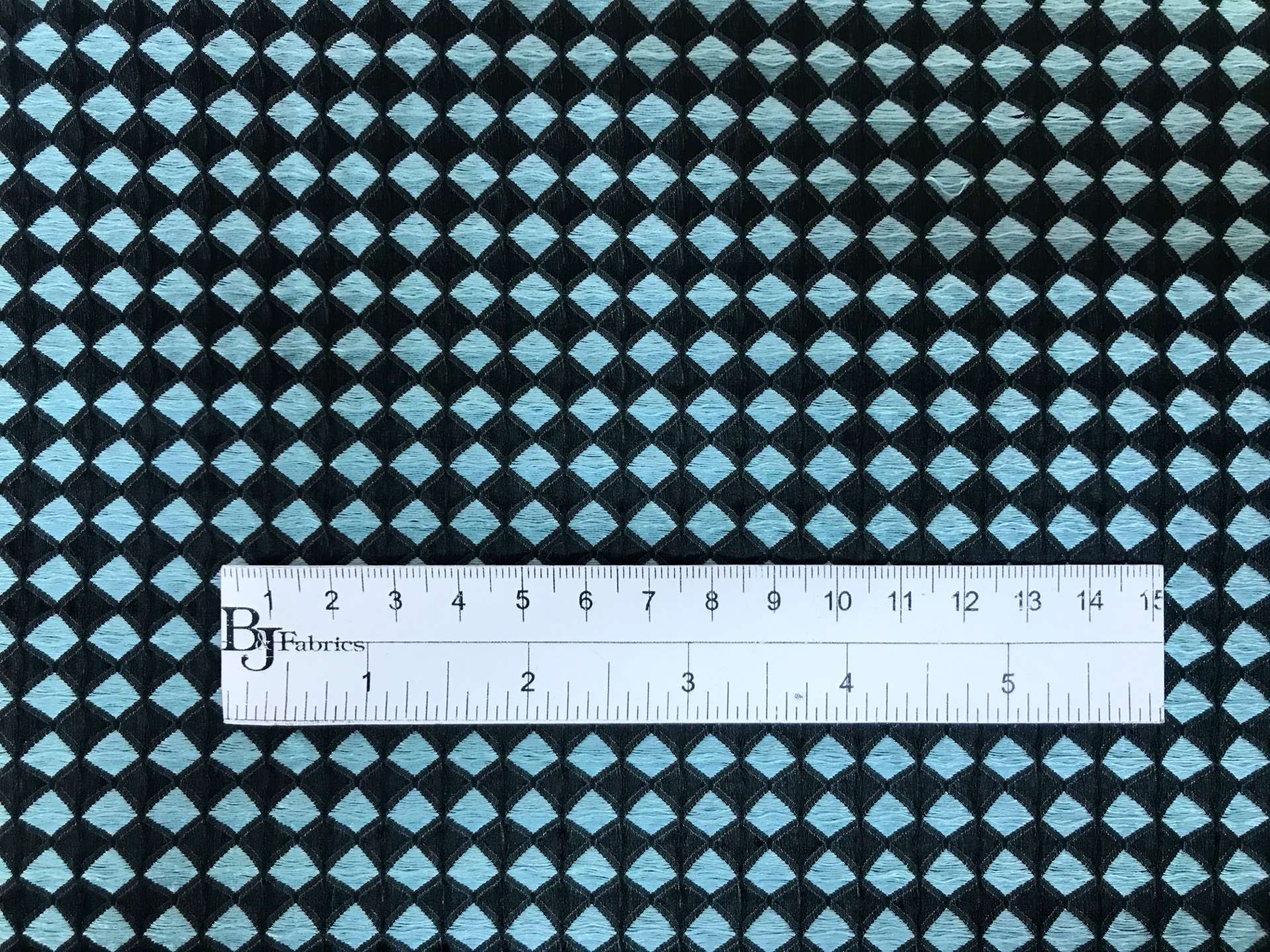 diamond geometric brocade in black and powder blue with ruler to show scale