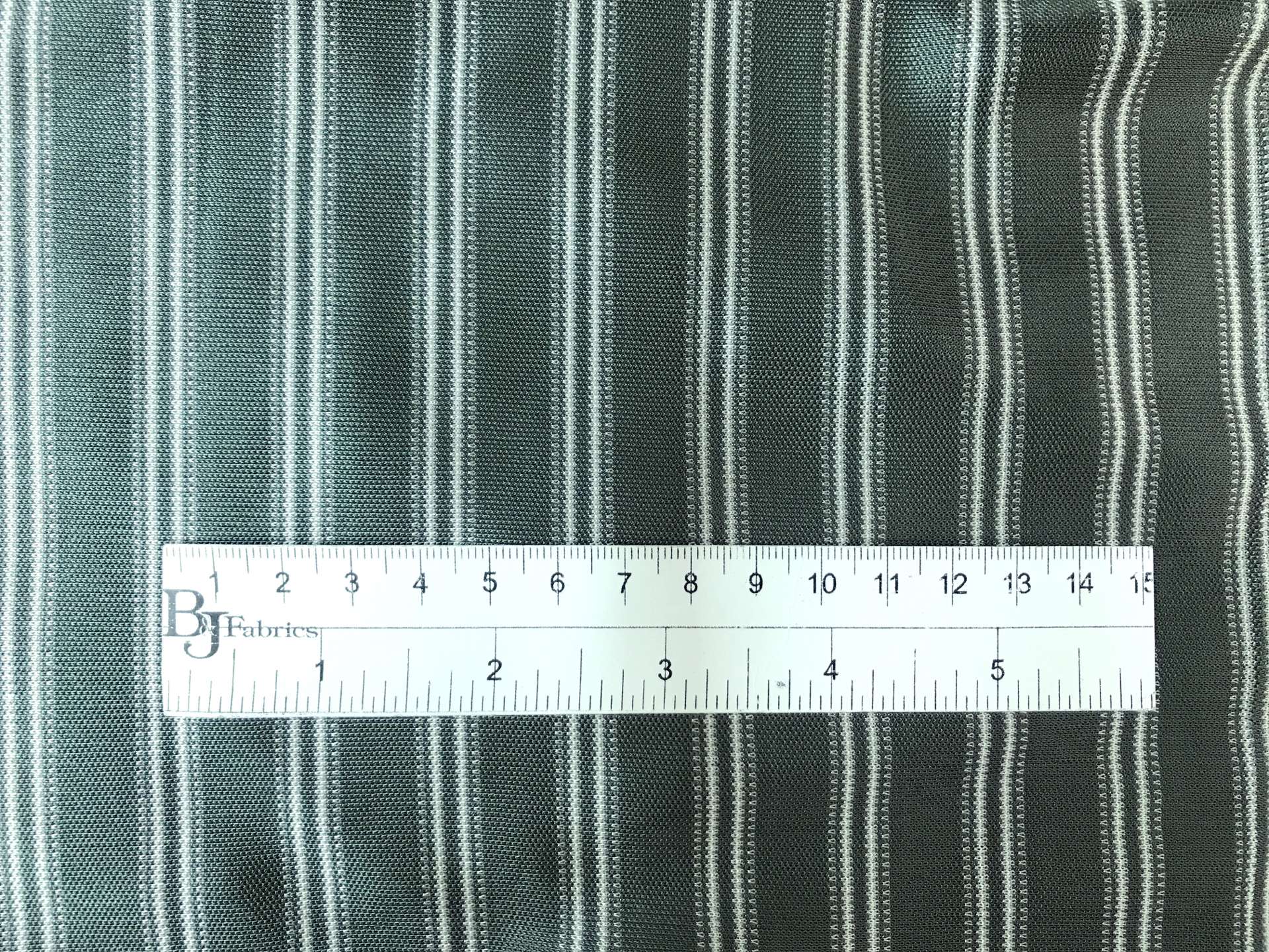 rayon jersey stripe in sage with ruler to show scale