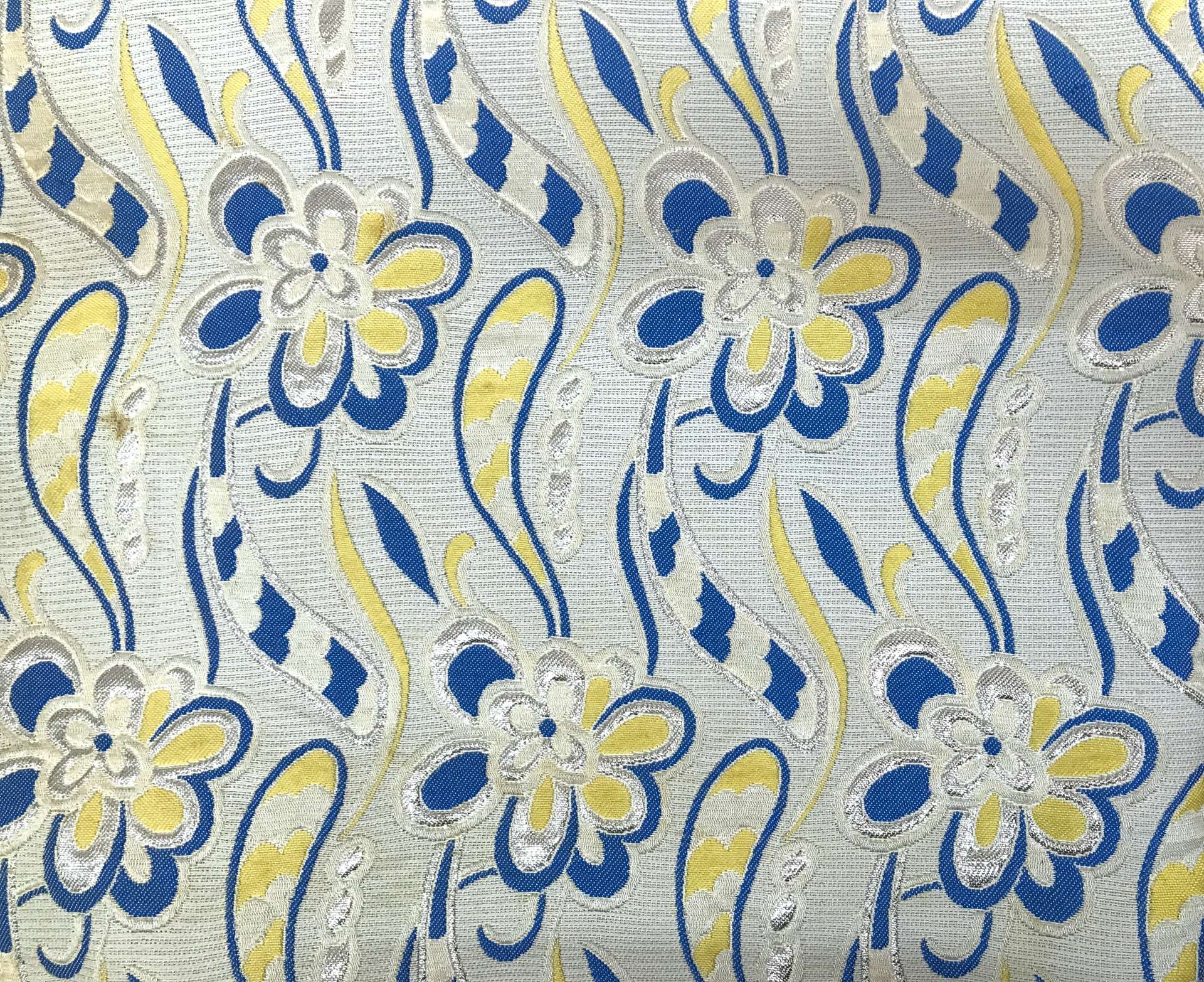 vintage brocade with 60s-esque florals in silver, yellow, and blue 