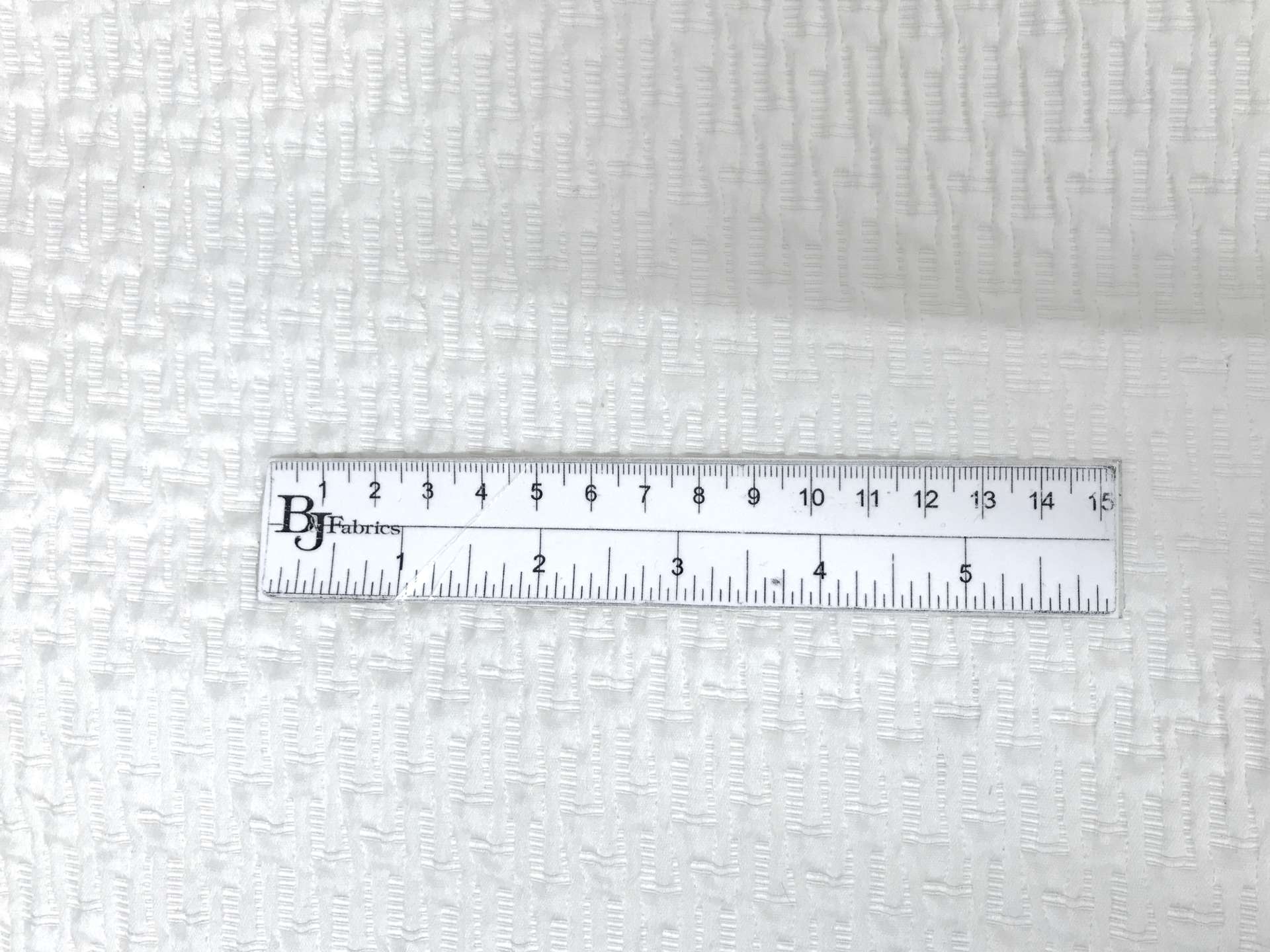 Italian Silk and Polyester Stretch Brocade in White with ruler to show scale
