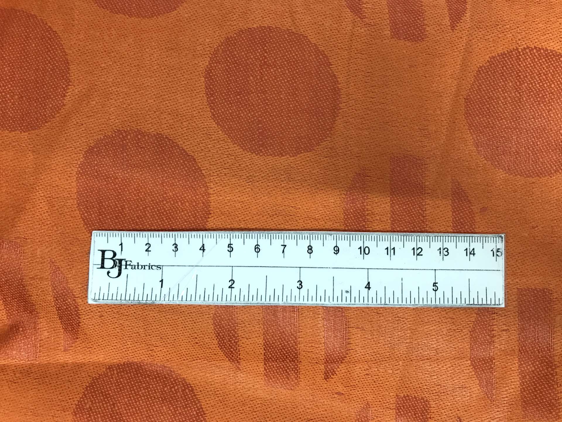 Italian Linen Jacquard in Bright Orange with ruler to show scale