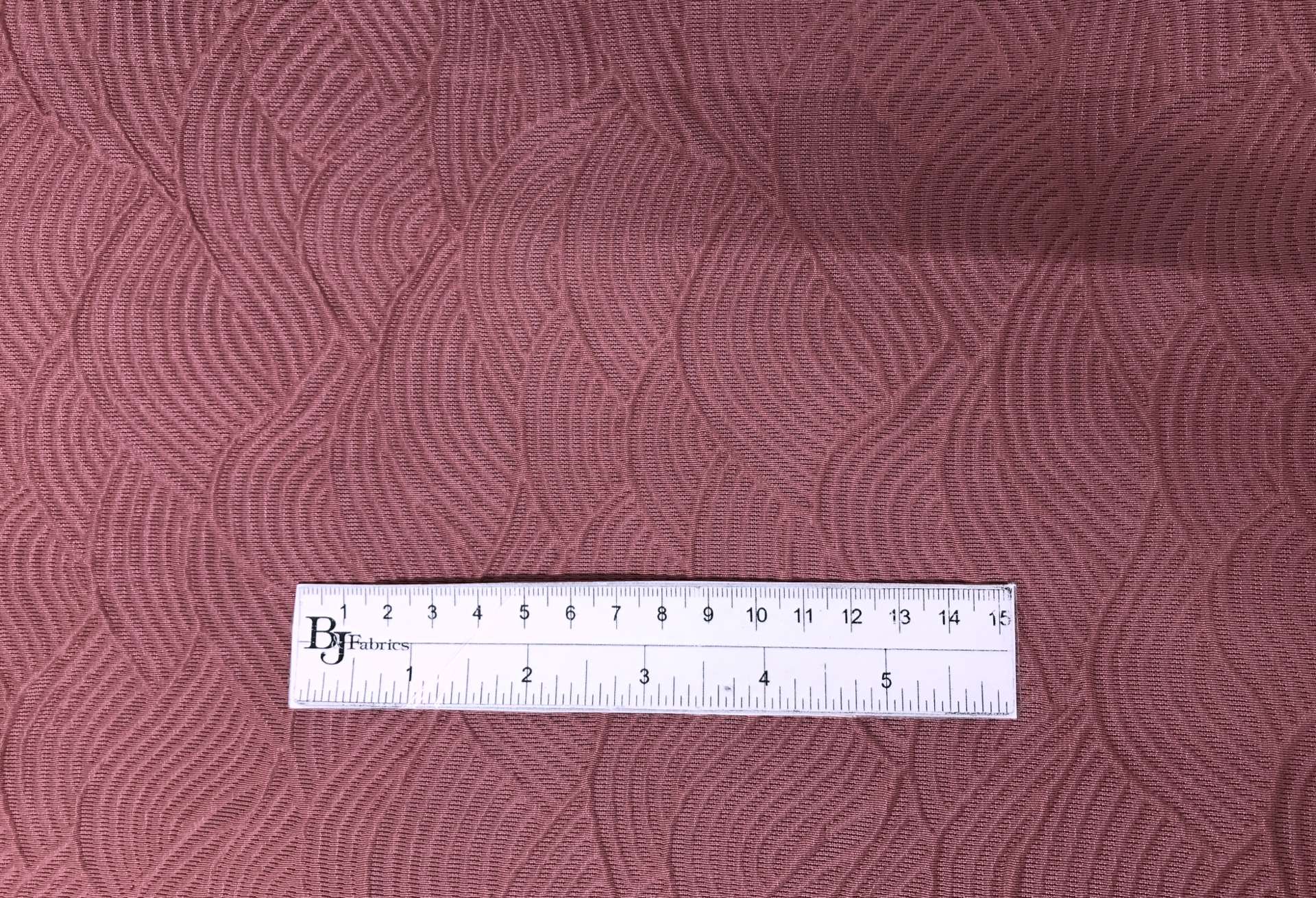Rayon Blend Matelassé with Wave Patterns with ruler to show scale