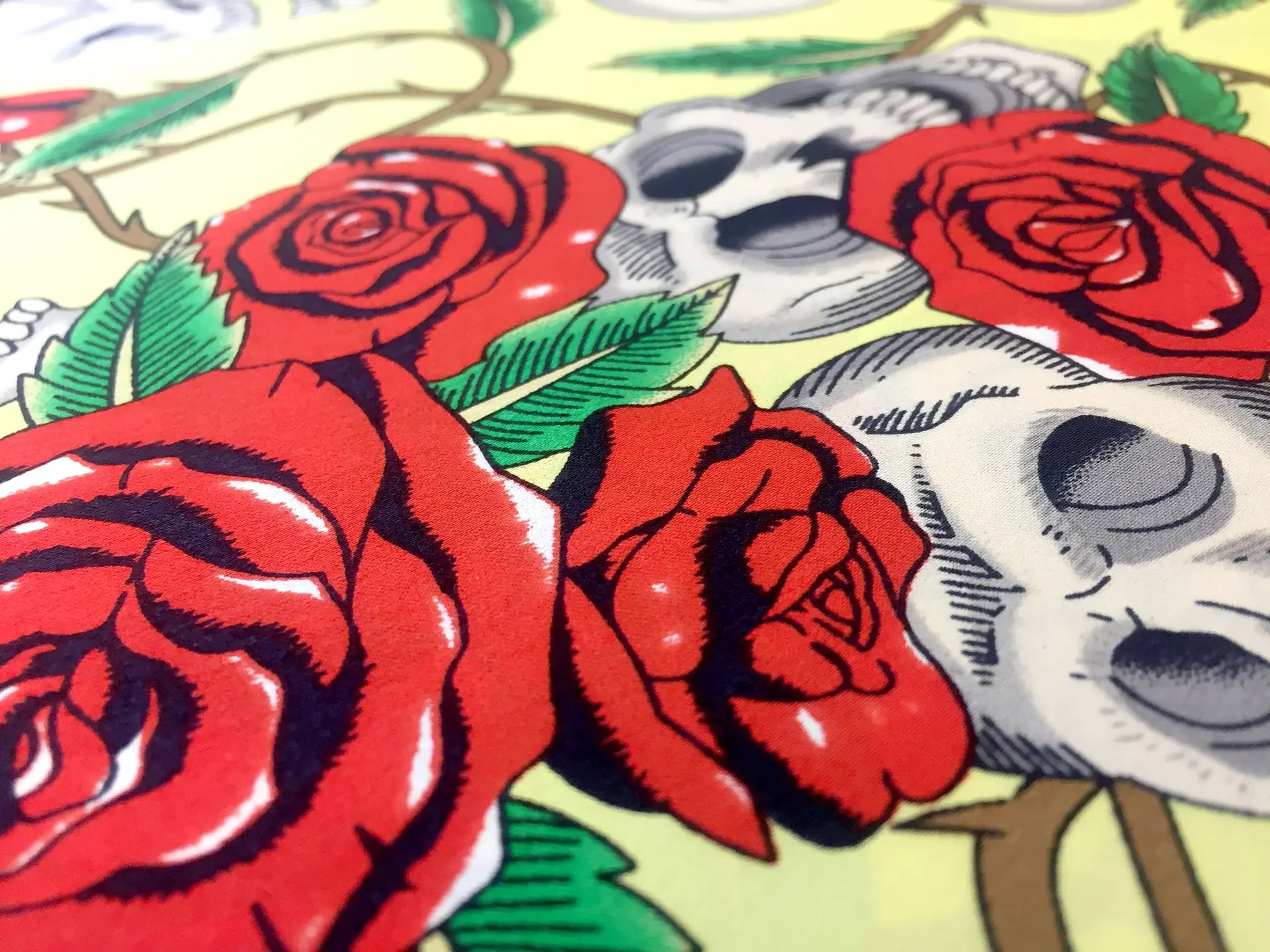 Printed Silk Charmeuse with Skulls and Roses on Yellow Background