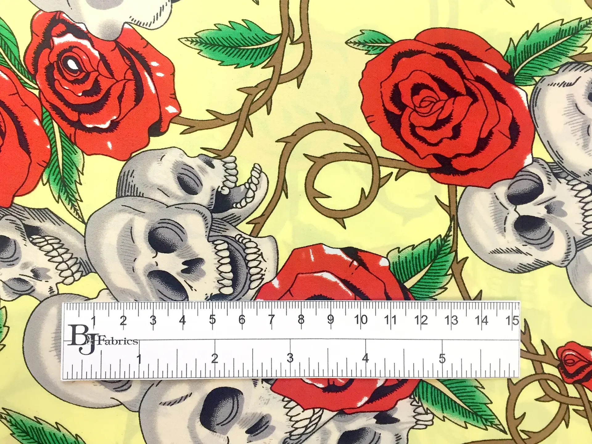 Printed Silk Charmeuse with Skulls and Roses on Yellow Background