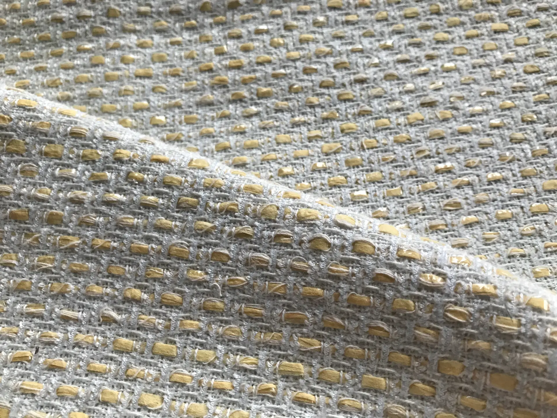 tweed folded to show the texture and shine of the raffia