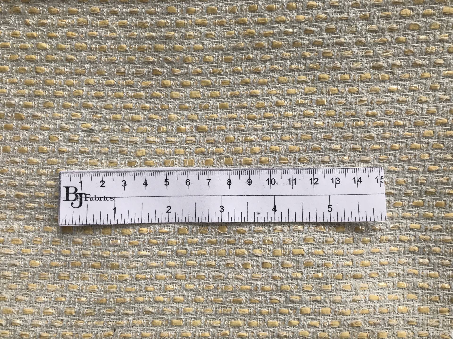 ruler lays on top of tweed to show scale of weave