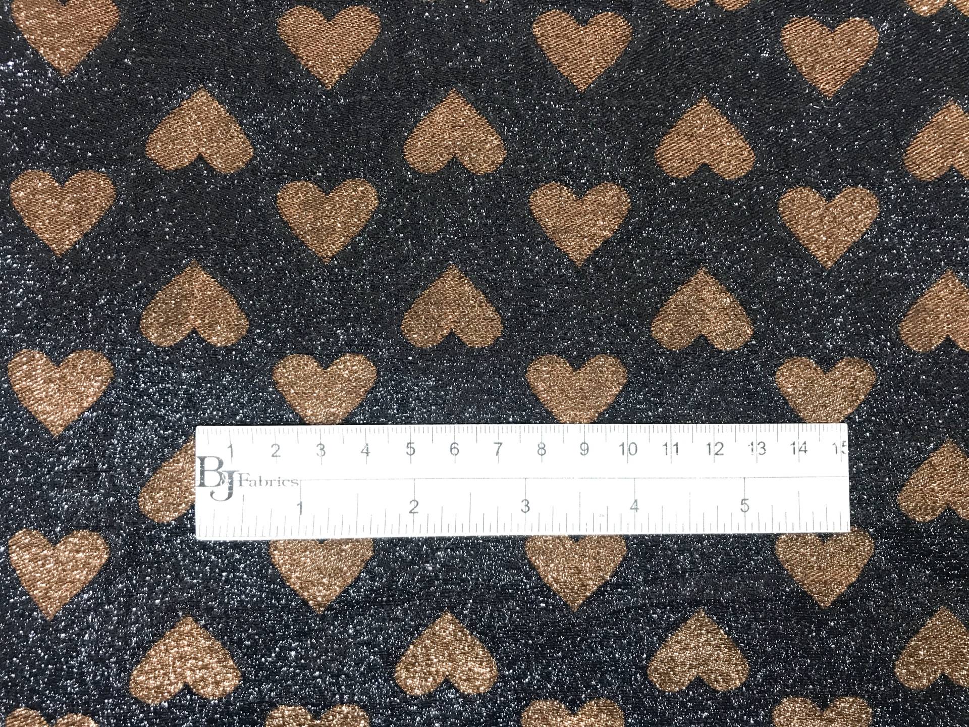 black metallic chiffon with brown hearts with ruler to show scale