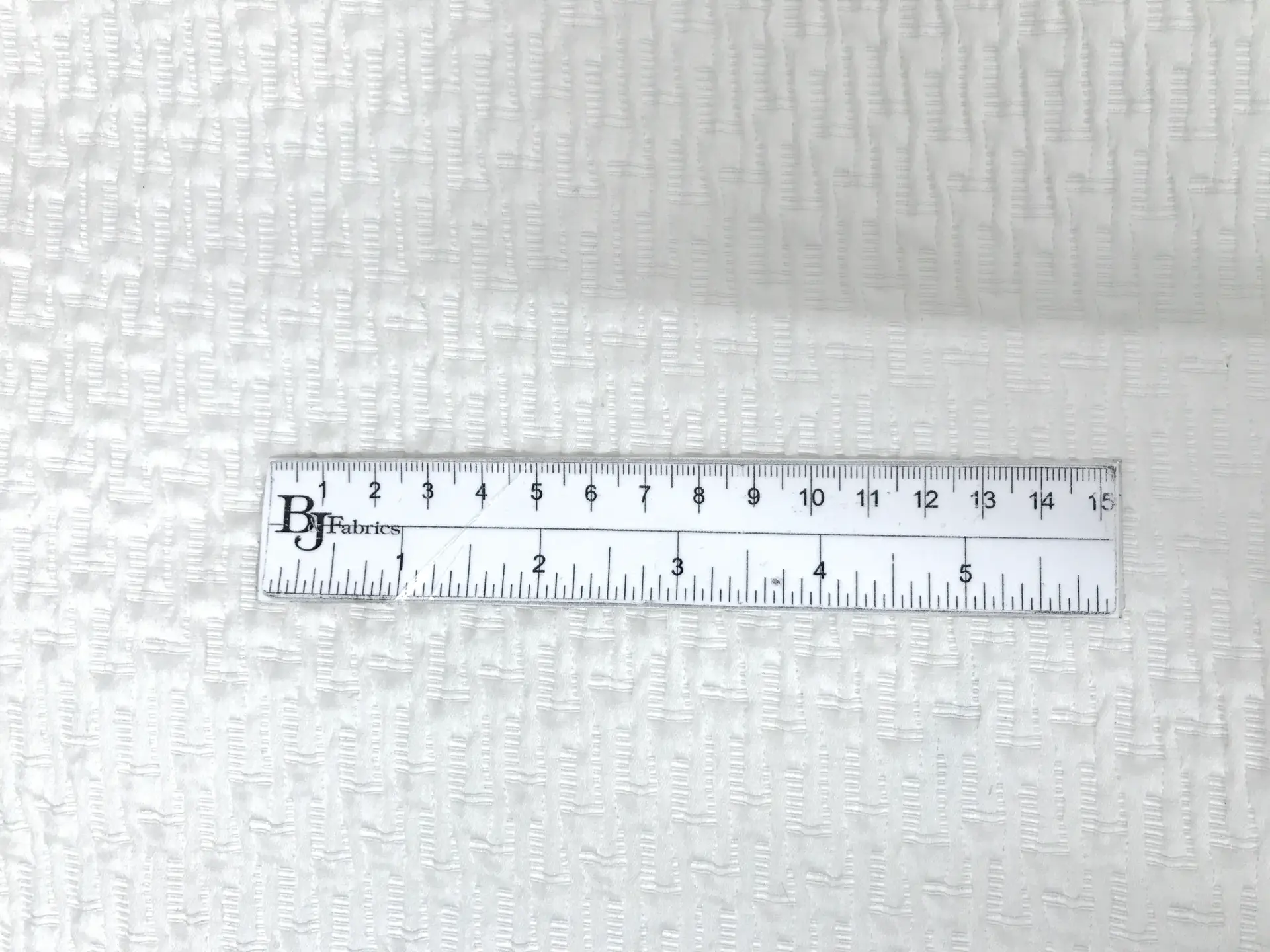 Italian Silk and Polyester Stretch Brocade in White with ruler to show scale