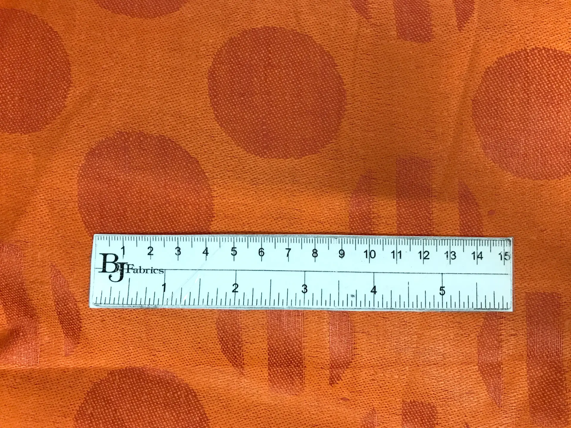 Italian Linen Jacquard in Bright Orange with ruler to show scale