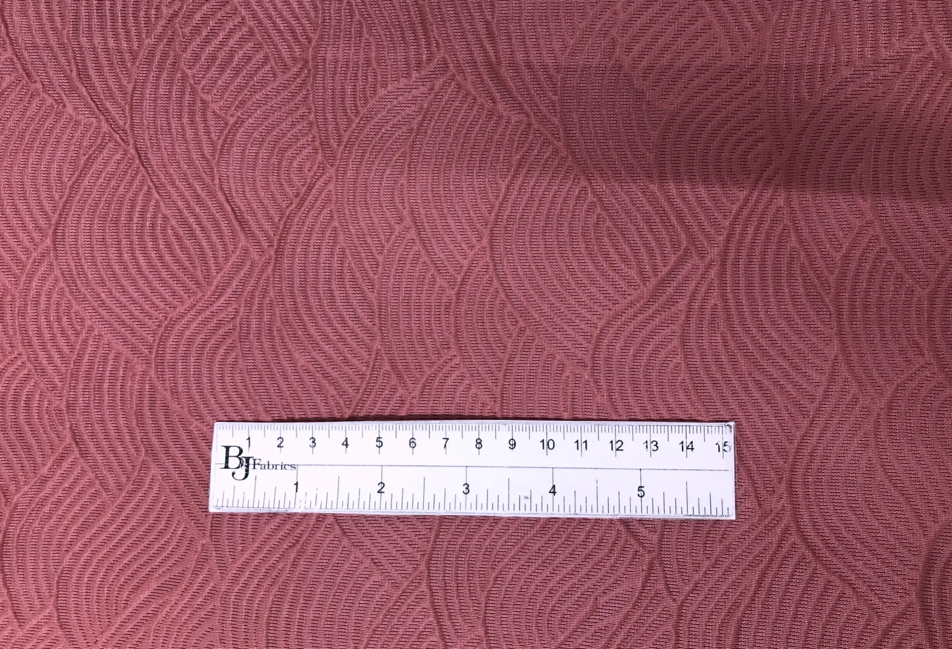 Rayon Blend Matelassé with Wave Patterns with ruler to show scale