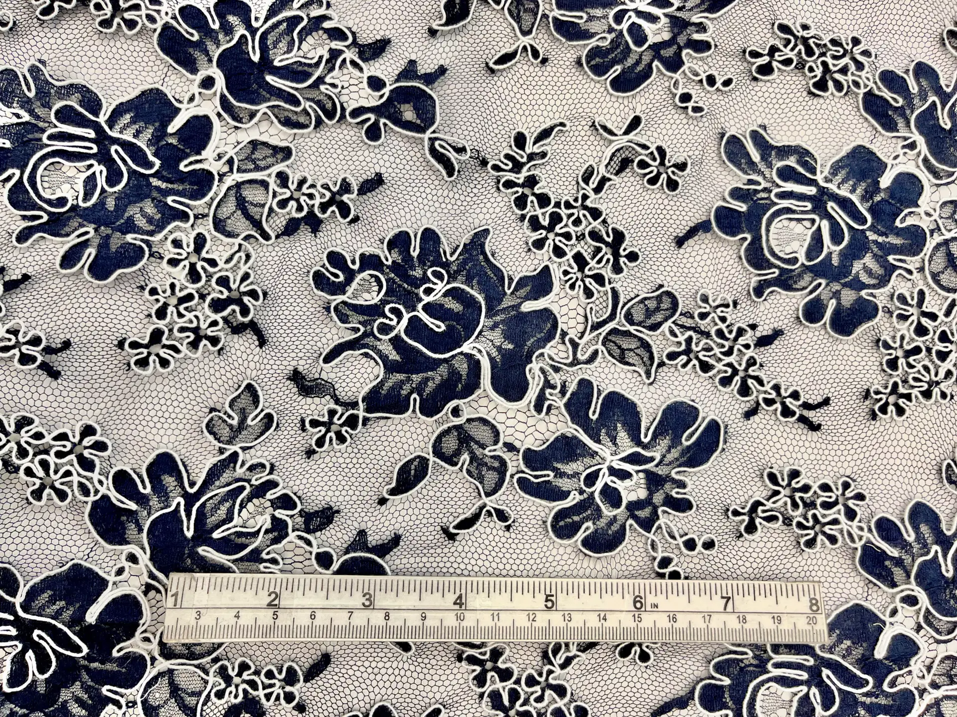 French Navy Blue Alençon Lace with Roses Outlined by White Cordings.
